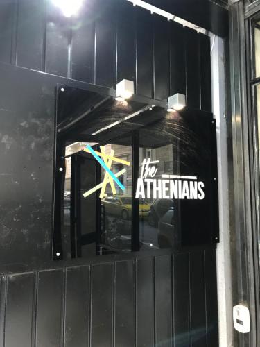 a window in a building with a sign on it at The Athenians Modern Apartments in Athens