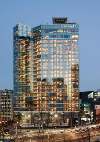 a tall building with many windows in a city at Park Hyatt Seoul in Seoul