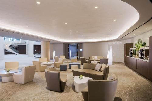 a waiting room with couches and chairs and tables at Grand Hyatt Incheon in Incheon