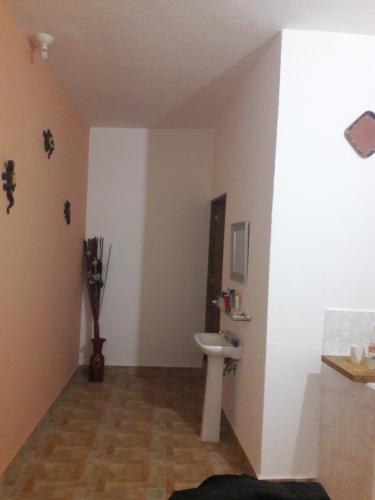 a bathroom with a sink and a toilet at Hotel Villas Monteli Suites Cuernavaca in Cuernavaca