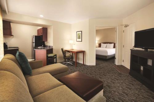 a hotel room with a couch and a bed at Hyatt House Pleasanton in Pleasanton