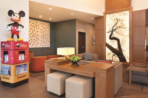 a living room with a mickey mouse on the wall at Hyatt Place at Anaheim Resort / Convention Center in Anaheim