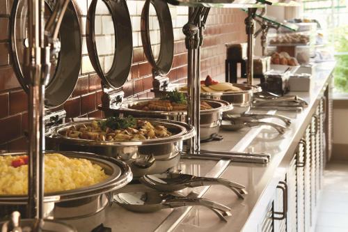 a buffet line with many dishes of food in pans at Hyatt House Pleasanton in Pleasanton