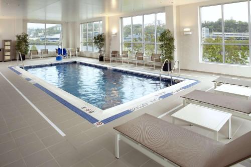 a large swimming pool in a large room with windows at Hyatt House Pittsburgh-South Side in Pittsburgh