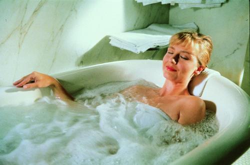a woman sitting in a bath tub at Arlington Resort Hotel & Spa in Hot Springs