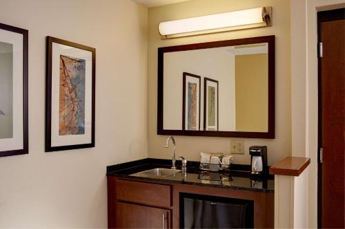 a bathroom with a sink and a mirror at Hyatt Place Richmond Chester in Woodvale