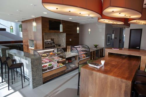 a restaurant with a counter with food on it at Hyatt Place Santiago/Vitacura in Santiago