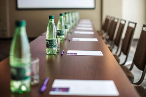a long wooden table with bottles on it at Hyatt Place Santiago/Vitacura in Santiago