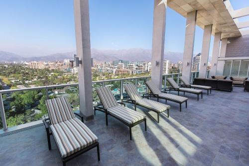 a row of chairs sitting on top of a balcony at Hyatt Place Santiago/Vitacura in Santiago