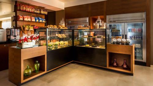 a display case in a store filled with lots of food at Hyatt Place Pune Hinjawadi in Pune