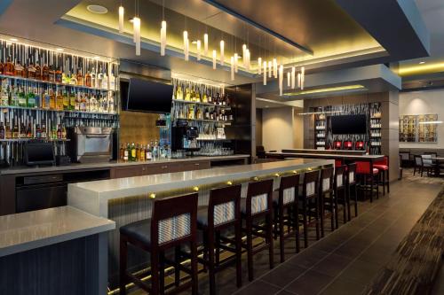 a bar with a row of bar stools at Hyatt Place Chicago/Downtown - The Loop in Chicago