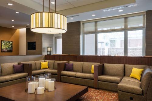 a waiting room with couches and a table at Hyatt House Charleston - Historic District in Charleston