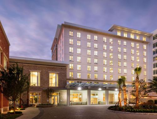 a large white building with many windows at Hyatt House Charleston - Historic District in Charleston