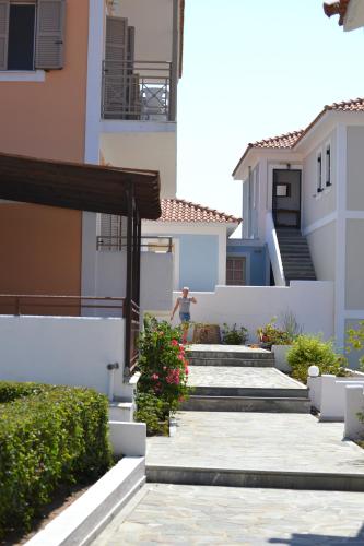 a man walking down the stairs of a house at Mykali Hotel in Pythagoreio