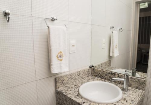 a bathroom with a sink and a mirror at Hotel Imperador in Salgueiro