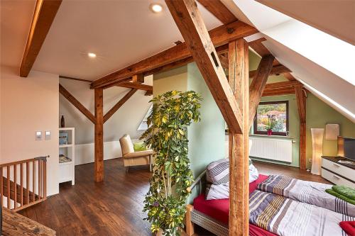 a living room with wooden beams and a couch at Ferienwohnung Schulze in Freital