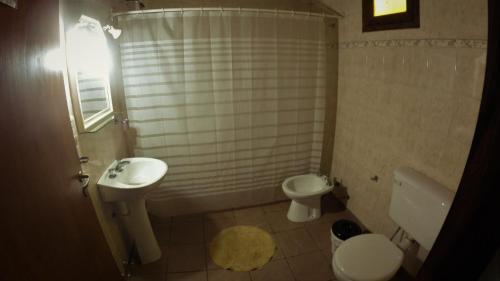 a small bathroom with a sink and a toilet at marangatu apart hotel in Puerto Iguazú