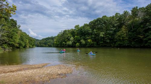 a group of people in kayaks on a river at Carter Caves State Resort Park in Olive Hill