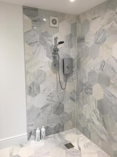 a bathroom with a shower with a stone wall at Oak-Island Hall in Huntingdon