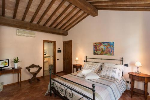 a bedroom with a bed in a room with wooden ceilings at Pisa Holidays in Pisa