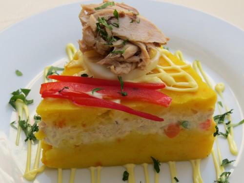a piece of food on a plate with pasta at Hotel Las Flores in Ica