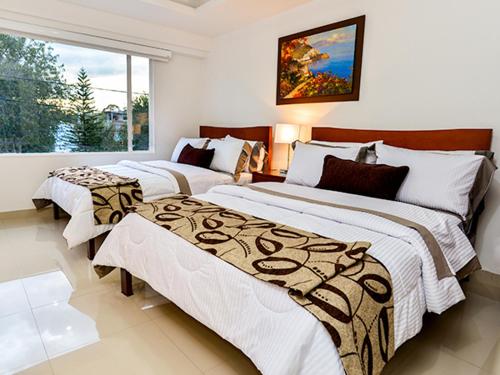 Postel nebo postele na pokoji v ubytování Hotel Fontanar Usaquen
