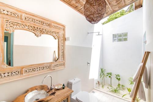 a bathroom with a mirror and a sink at Villa Rosa Maldives in Feridhoo