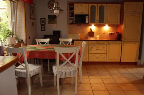 a kitchen with a table and chairs in a room at Ranczo w Dolinie Karpia - blisko "Energylandii" Zator in Spytkowice