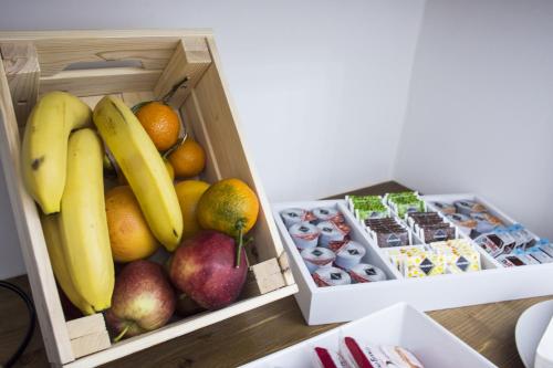 a box of fruit with bananas apples and other foods at I Borbone in Caserta