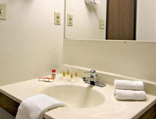 a bathroom with a white sink and a mirror at Super 8 by Wyndham Twinsburg/Cleveland Area in Twinsburg