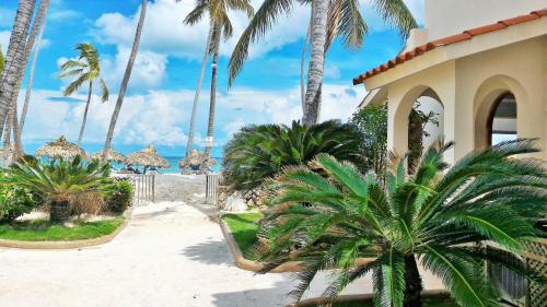 a resort with palm trees and a beach with the ocean at La Flor del Caribe Beach & SPA in Punta Cana