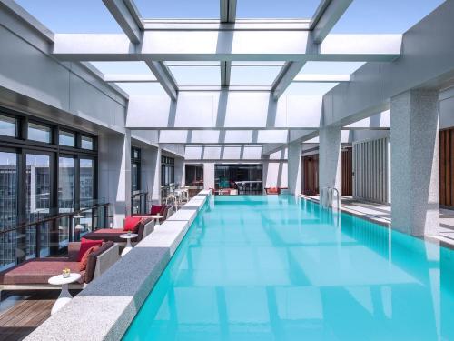 a room with a pool, chairs, and a pool table at Cordis Shanghai Hongqiao (Langham Hospitality Group) in Shanghai