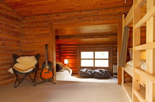 a room with a guitar in a log cabin at Niseko Backcountry Lodge in Niseko