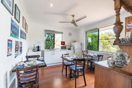 a kitchen and dining room with a table and chairs at Torquay Terrace Bed & Breakfast in Hervey Bay