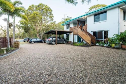 a car that is parked in front of a house at Torquay Terrace Bed & Breakfast in Hervey Bay