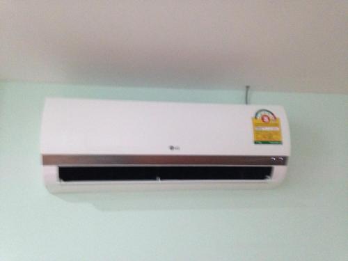 a air conditioner is hanging on a wall at J&E in Nong Prue