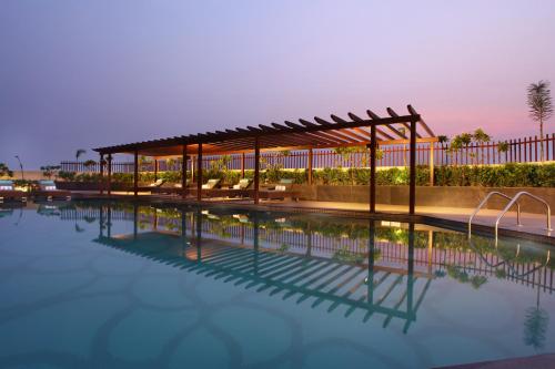 a swimming pool with a pavilion next to a building at Radisson Blu Jammu in Jammu