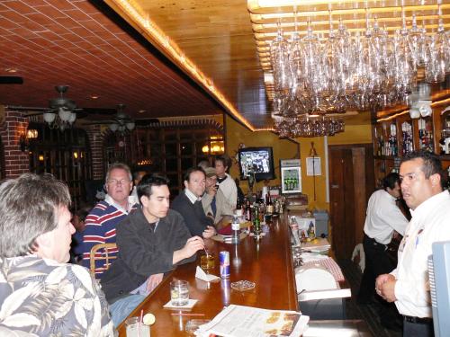 a group of people sitting at a bar in a restaurant at Hotel La Hacienda de la Langosta Roja in San Felipe