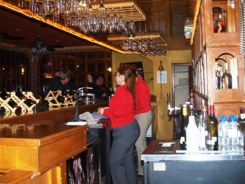 two women standing at a bar in a pub at Hotel La Hacienda de la Langosta Roja in San Felipe