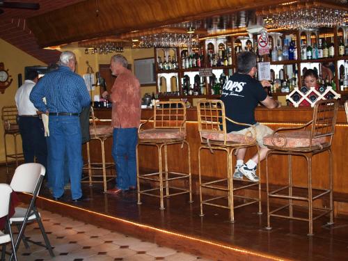 a group of men standing at a bar at Hotel La Hacienda de la Langosta Roja in San Felipe