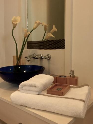 a bathroom with a sink and towels and a blue bowl at Marrakesh Residence 325 in Hua Hin