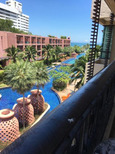 a view of the pool from the balcony of a resort at Marrakesh Residence 325 in Hua Hin