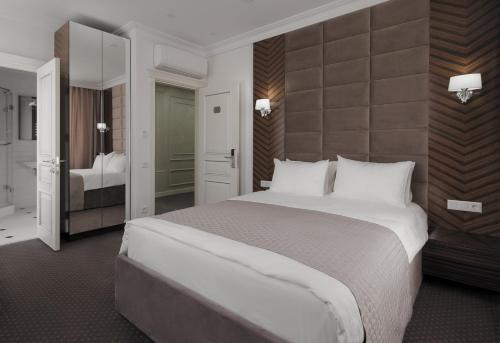 a hotel room with a large bed and a bedroom at London Boutique Hotel in Chişinău