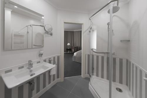 a bathroom with a sink and a shower at London Boutique Hotel in Chişinău
