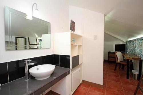 a bathroom with a sink and a mirror at Bluewaves Beach House in Boracay