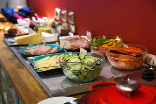 a buffet with bowls of food on a table at Hellstens Glashus in Stockholm