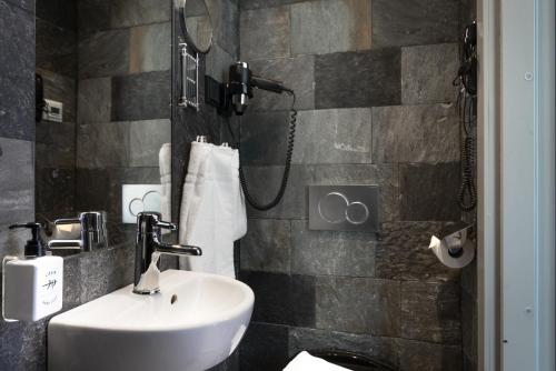 a bathroom with a sink and a shower at Hellstens Glashus in Stockholm