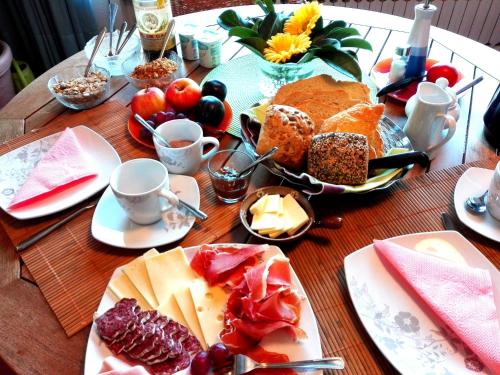 a wooden table with plates of food on it at Chalet "Rec dels Noguers" in Castellciutat