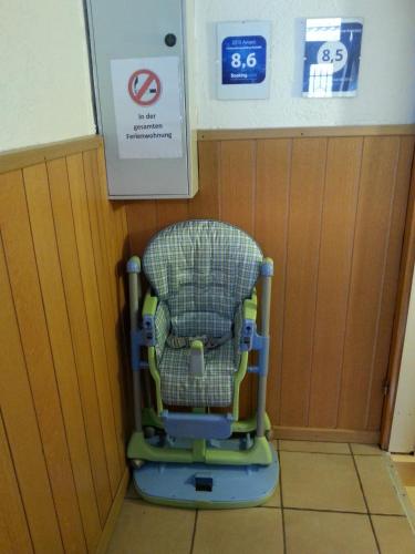 a chair in a room with a sign on the wall at Ferienwohnung Bottrop Radetzki in Bottrop