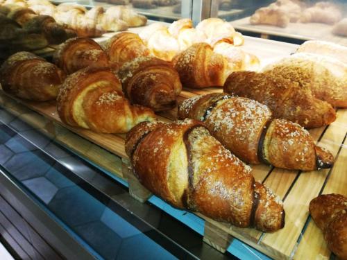 a display case filled with lots of different types of bread at Arianna in Salerno